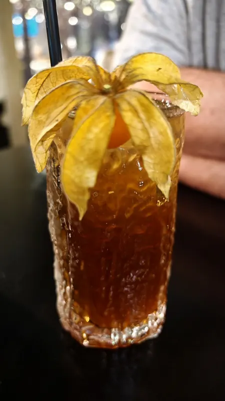 An amber cocktail crowned with physalis