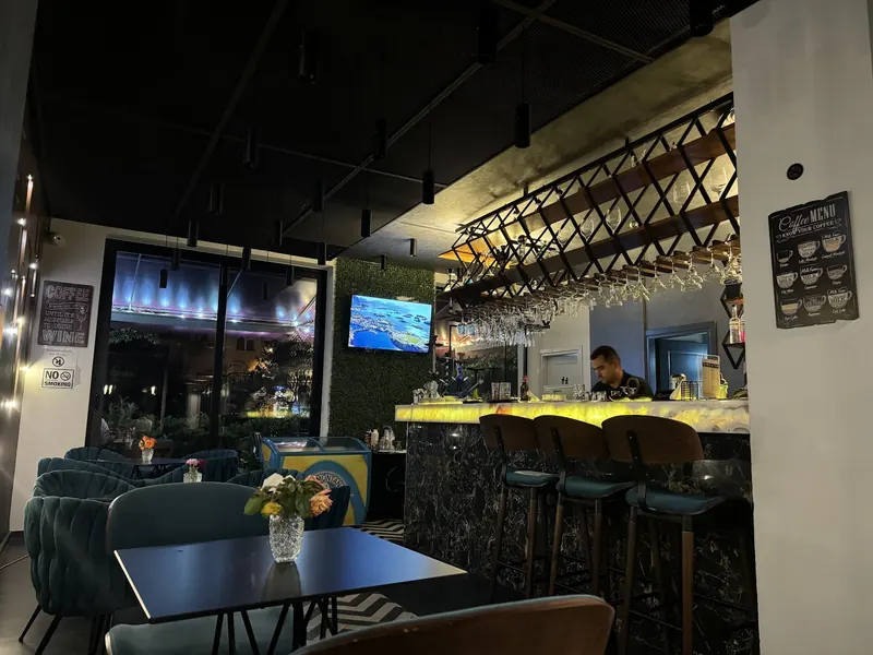 The bar at Bazar with its glowing counter and high stools