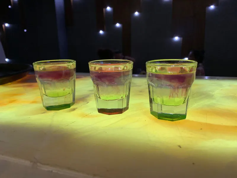 Three layered shots lined up on the bar
